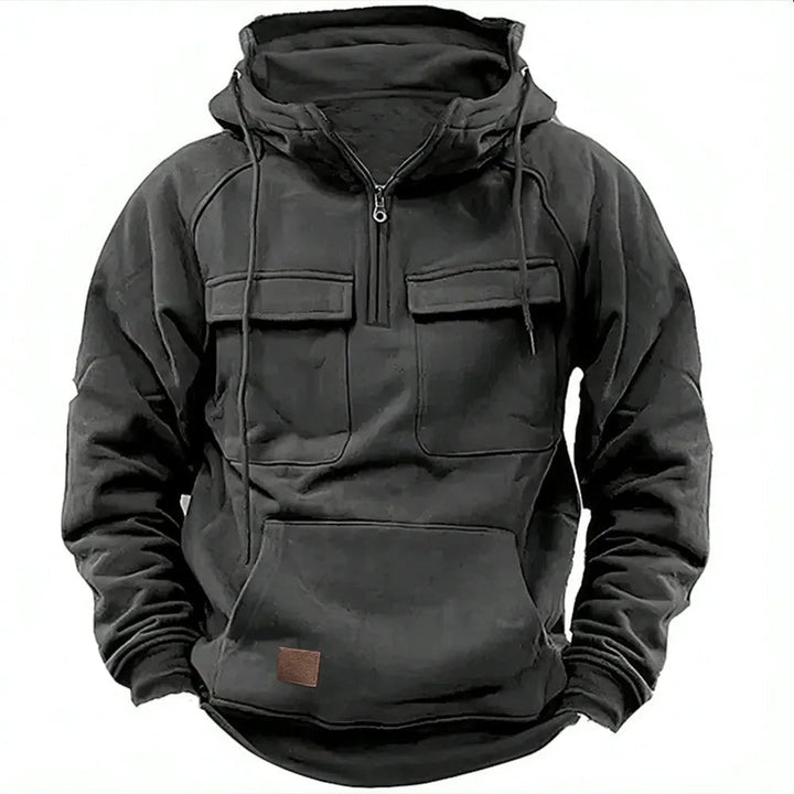 Black men's utility hoodie featuring a half-zip neckline, drawstring hood, dual chest flap pockets, and a kangaroo pocket.