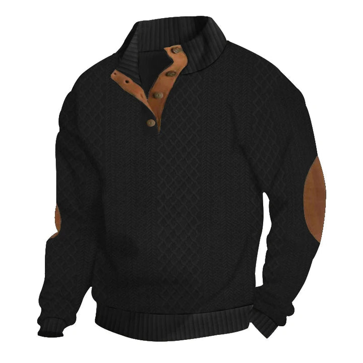 Black cable knit jumper with a button-up stand collar, tan leather-look elbow patches, and ribbed cuffs.