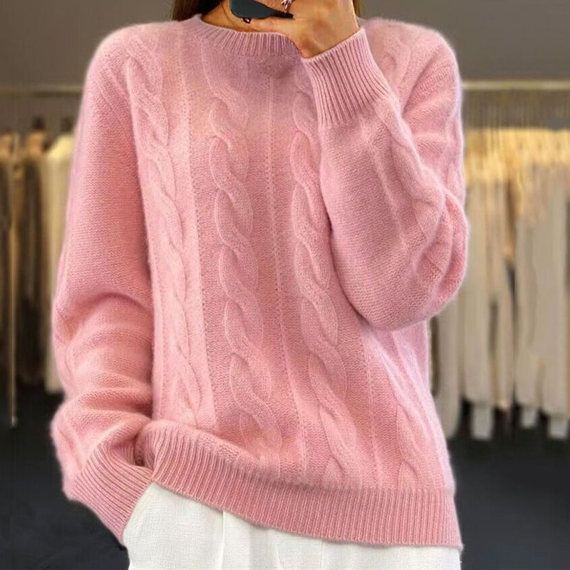 Soft pink cable knit jumper with a crew neckline, ribbed cuffs, and a relaxed fit.