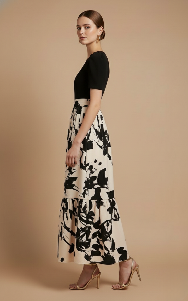 Rosalind Women's Short Sleeve Tiered Maxi Dress in black and white floral print, with a clean bodice and bow-tie waist.