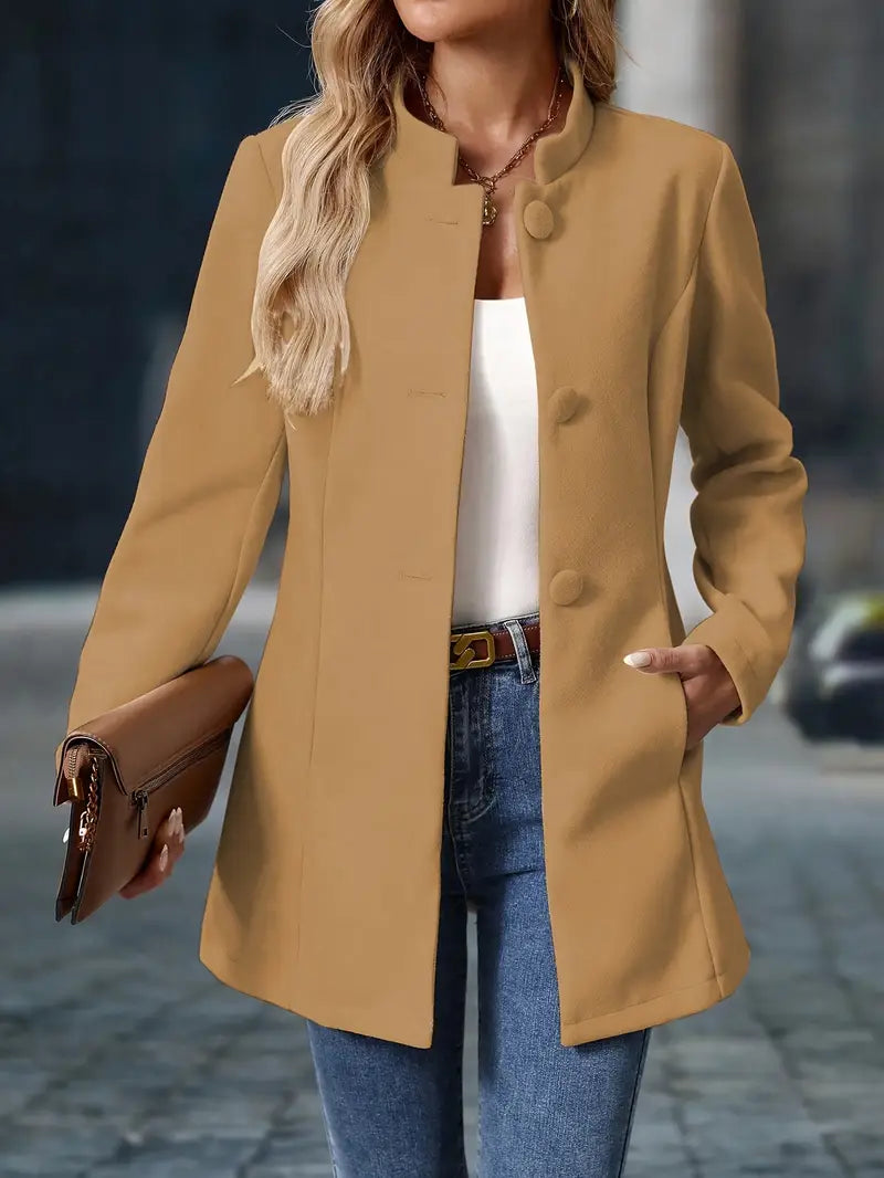 Camel-colored mid-length coat with a stand collar, tailored waist, and covered button-front closure.