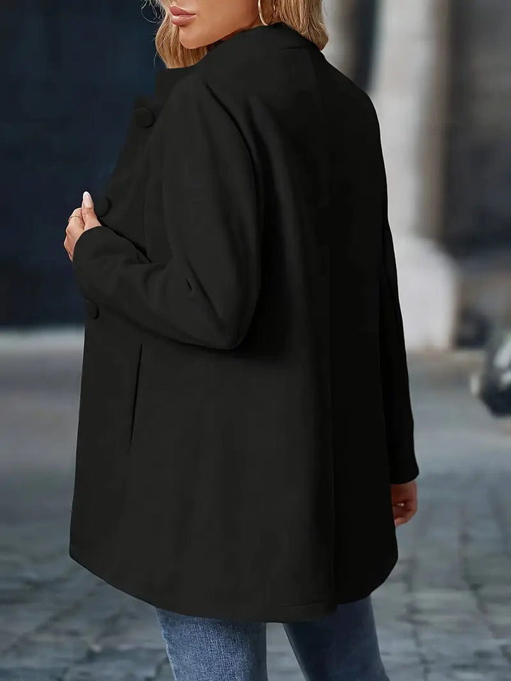 Black mid-length coat with a stand collar and button-front closure, tailored for a flattering fit.