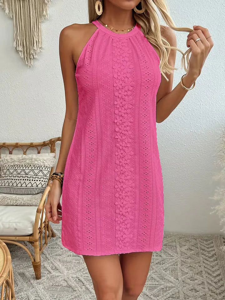 Hot pink eyelet halter mini dress featuring a floral lace center panel and a relaxed A-line silhouette.