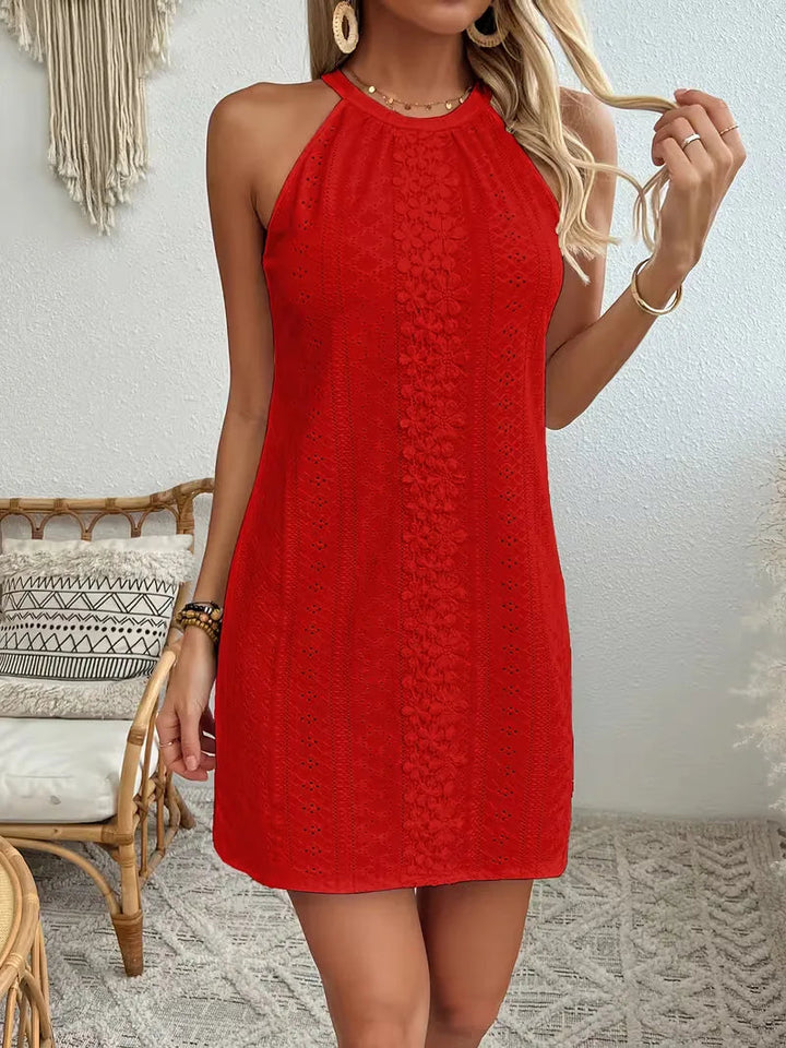 Red halter mini dress featuring delicate eyelet fabric and a floral lace center panel in a relaxed A-line silhouette.