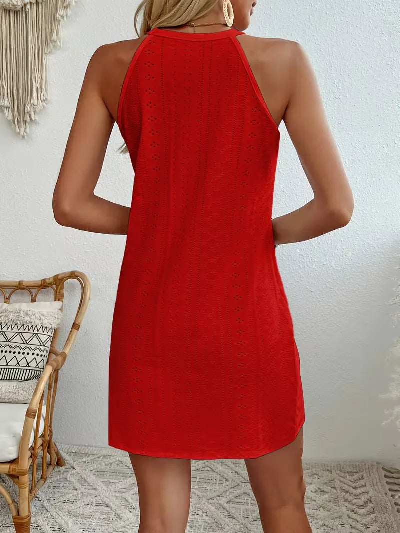 Back view of a red eyelet halter mini dress with a relaxed A-line silhouette and delicate lace detailing.