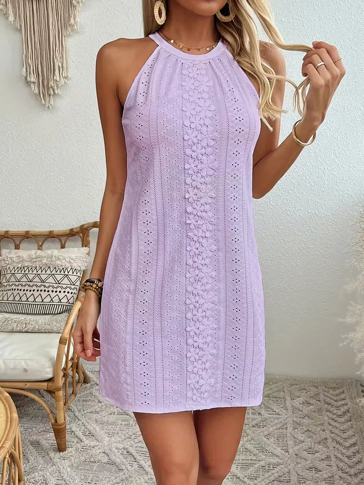 Lavender eyelet halter mini dress with a floral lace center panel and relaxed A-line silhouette.