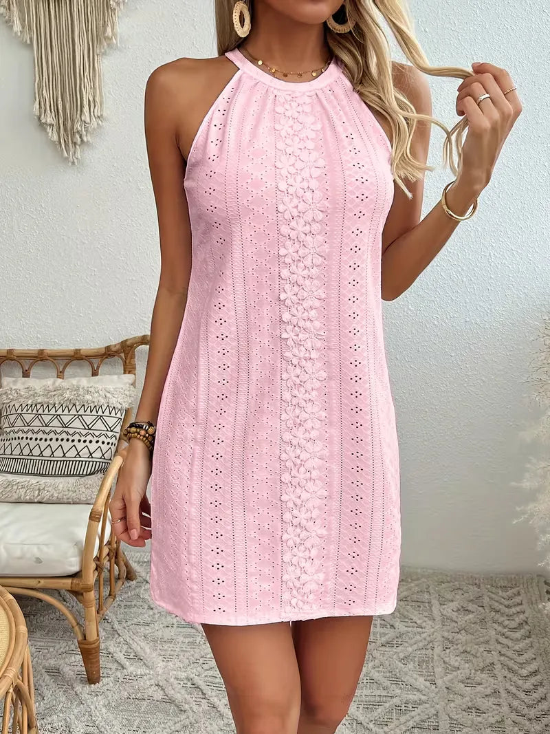 Light pink eyelet halter mini dress featuring a delicate floral lace center panel and a relaxed A-line silhouette.