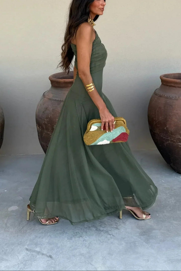 Rosie women's olive green one-shoulder pleated maxi dress, flowing elegantly with gold accessories.