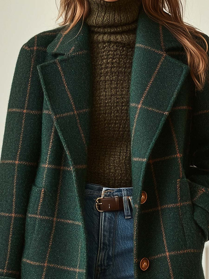Dark green wool-blend coat featuring a brown windowpane check pattern, notched lapels, and a button-front closure.