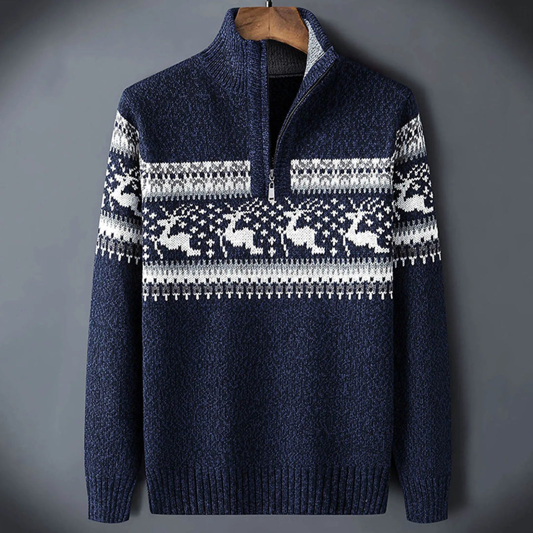 Navy blue knit half-zip jumper with a white Fair Isle reindeer pattern, stand collar, and ribbed cuffs.