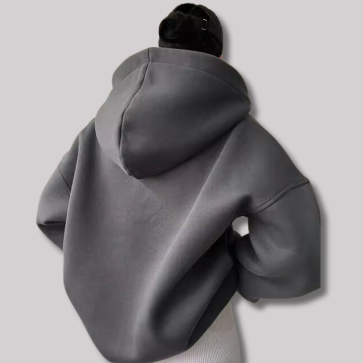 Charcoal grey oversized pullover hoodie with a deep hood and drop-shoulder design, viewed from the back.