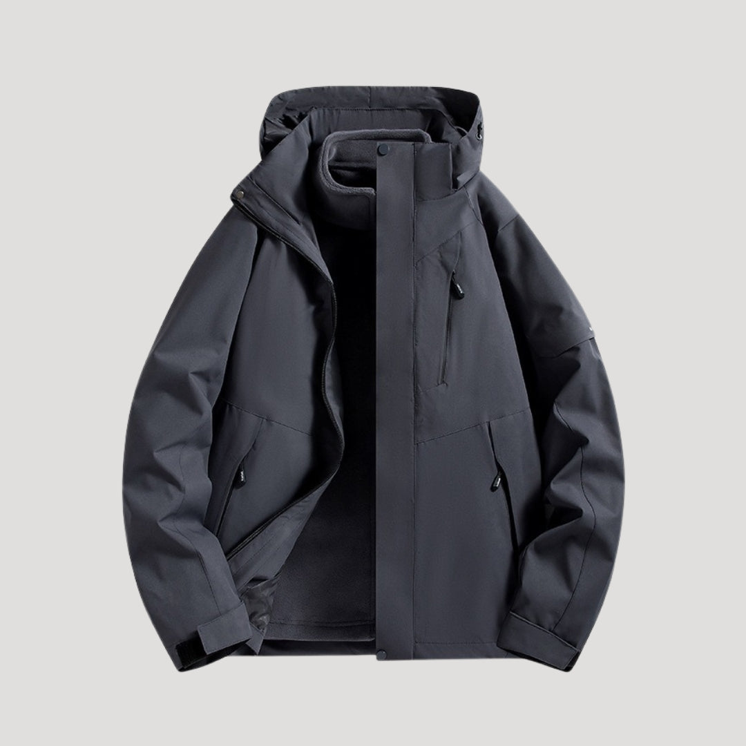 Charcoal grey waterproof windbreaker jacket with a hooded collar, zip-up front, and practical zippered pockets.