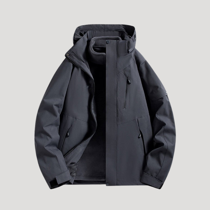 Charcoal grey waterproof windbreaker jacket with a hooded collar, zip-up front, and practical zippered pockets.