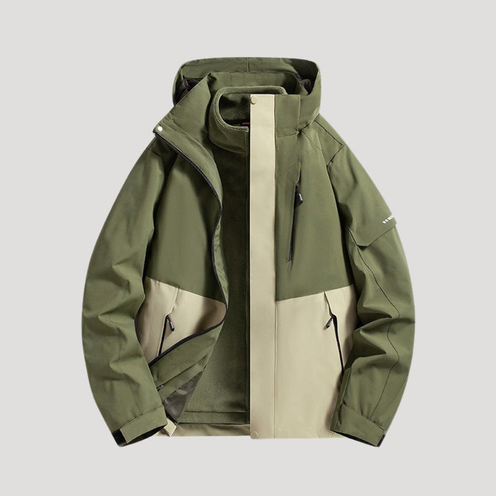 Olive green and beige waterproof hooded windbreaker with zip pockets and a fleece-lined interior on a light background.