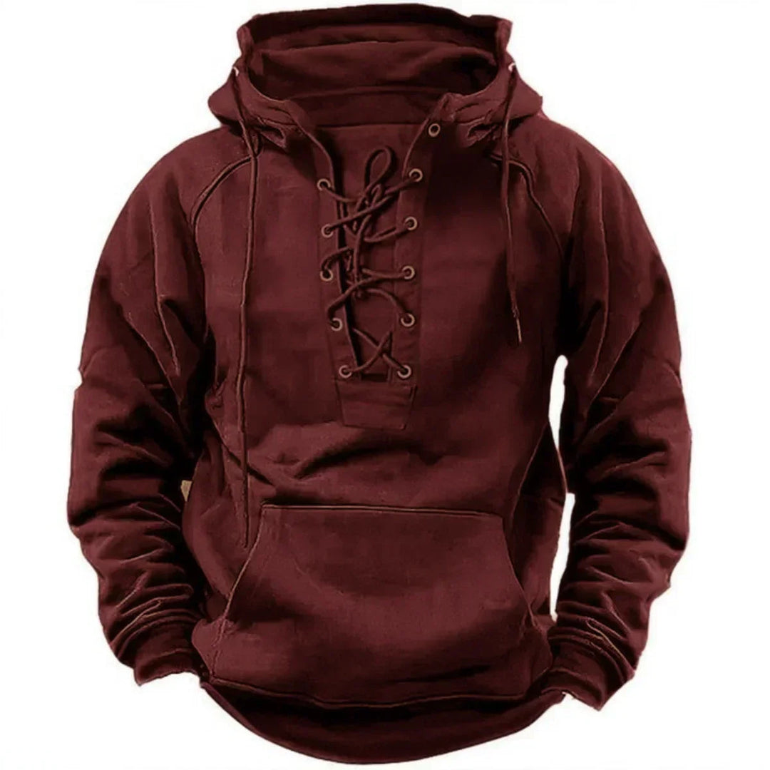 Men's burgundy pullover hoodie featuring a heritage lace-up neckline, metal eyelets, and a front kangaroo pocket.