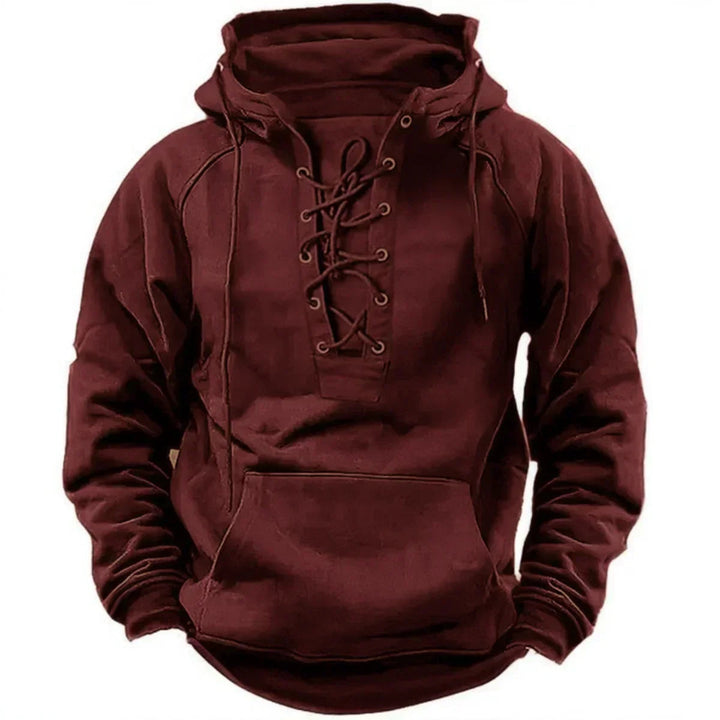 Men's burgundy pullover hoodie featuring a heritage lace-up neckline, metal eyelets, and a front kangaroo pocket.