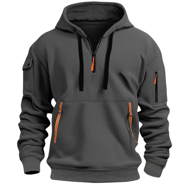 Charcoal grey men's half-zip hooded sweatshirt with orange zip pulls, multiple secure pockets, and ribbed cuffs.