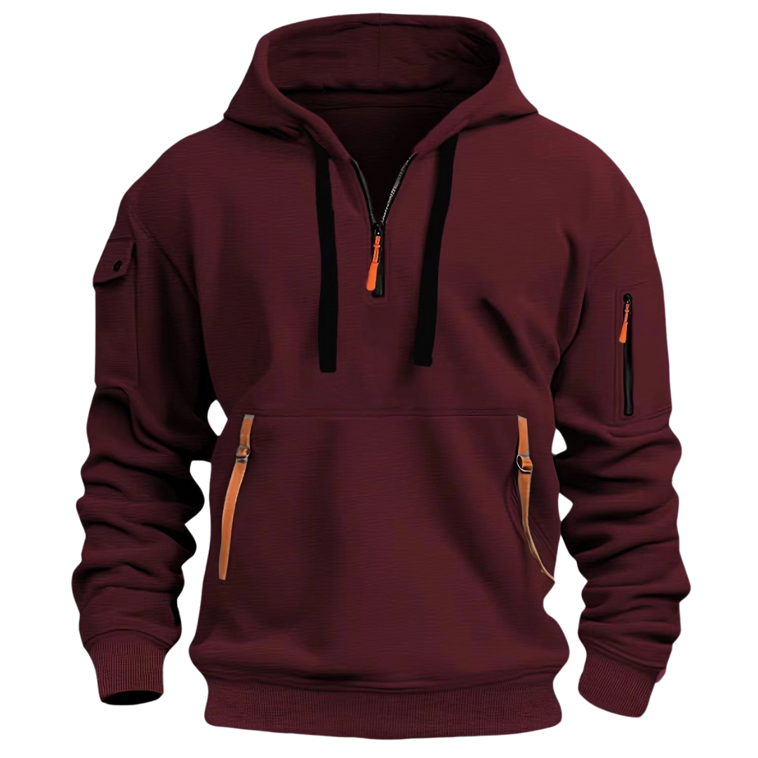 Burgundy men's half-zip hooded sweatshirt with contrast orange zip pulls, sleeve pockets, and a front kangaroo pouch.
