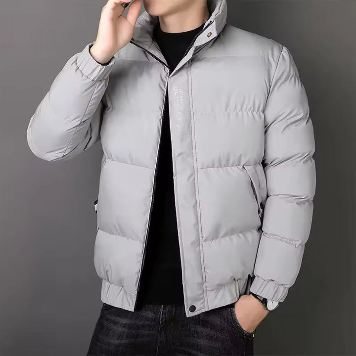 Men's light grey puffer jacket with a stand collar, full-length zip, and quilted insulated construction.