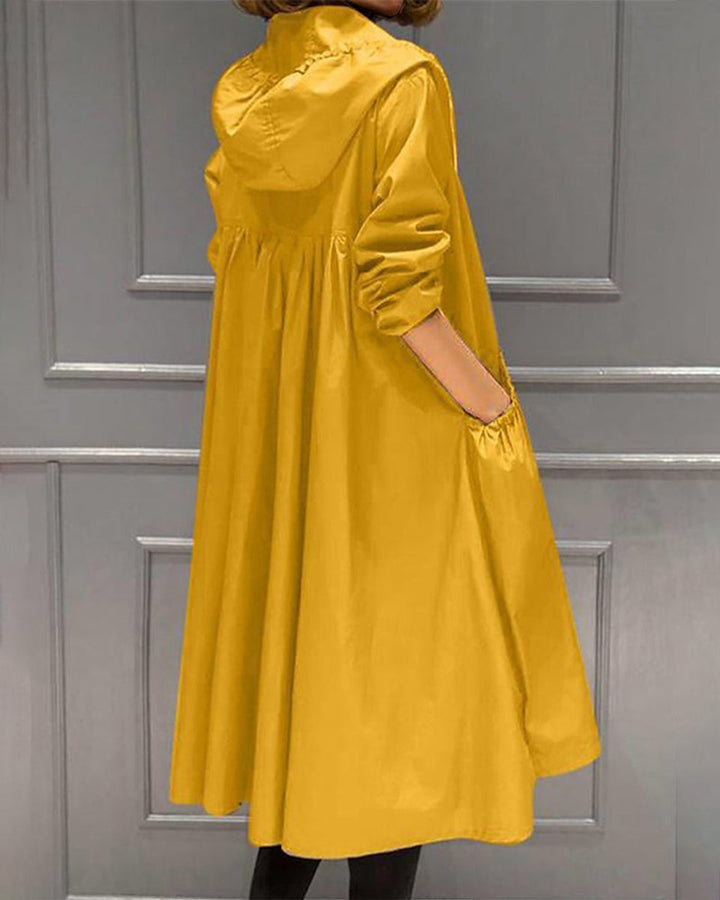 Mustard yellow waterproof A-line trench coat featuring a ruched waist, adjustable hood, and practical side pockets.