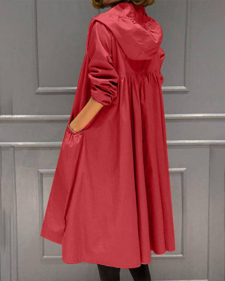 Red waterproof A-line trench coat featuring a hooded design, ruched waist, and practical side pockets.