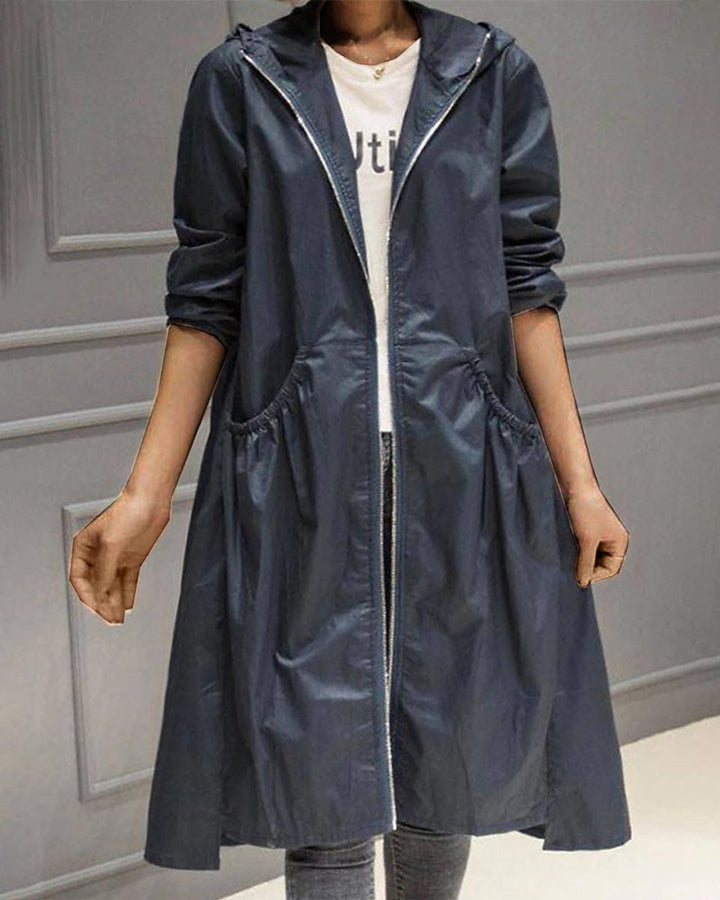 Navy blue waterproof A-line trench coat featuring a hooded zip-up design and flattering ruched waist detailing.