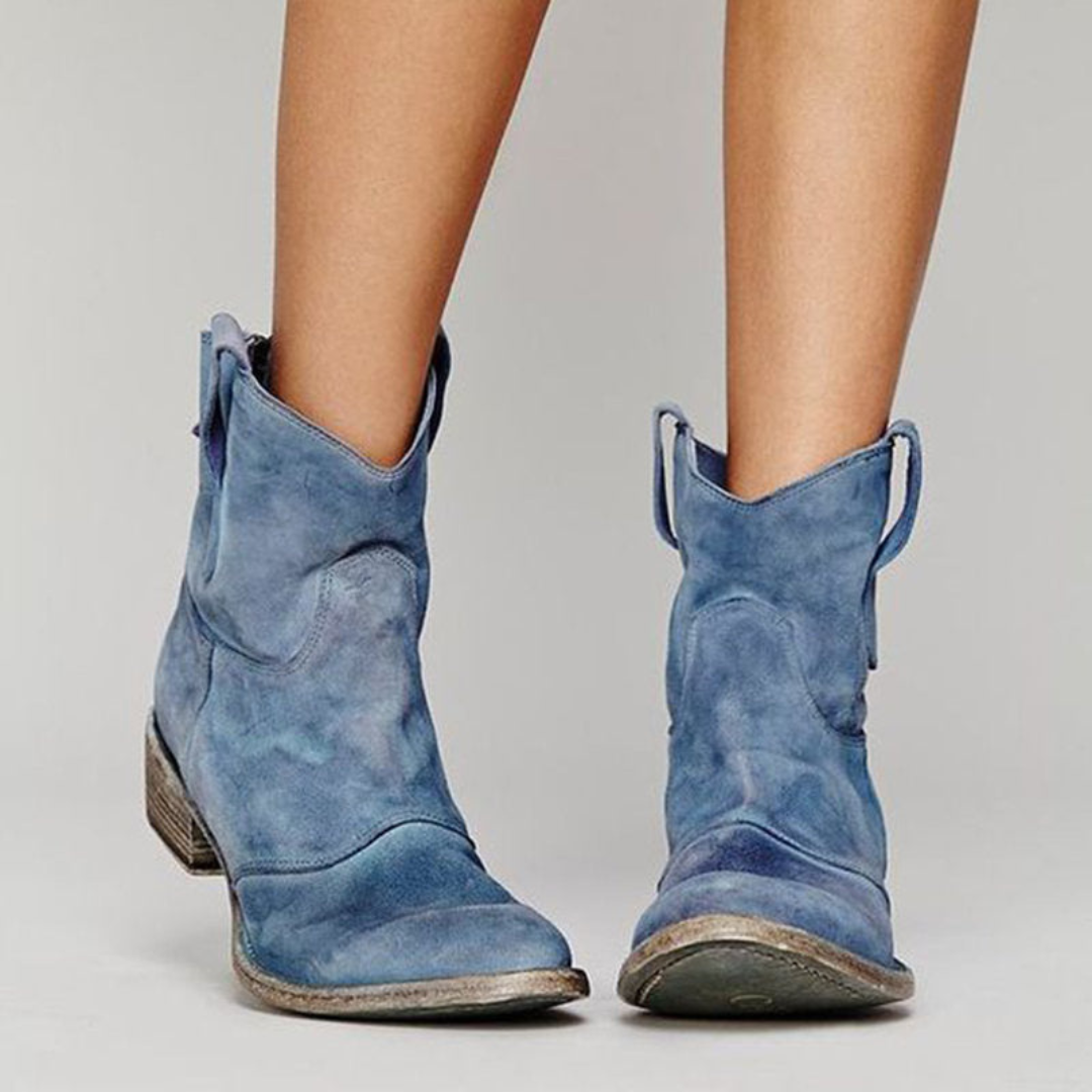 Blue suede-look western ankle boots with a low block heel and pull tabs for a stylish, worn-in casual look.