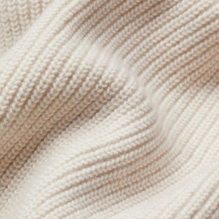 Close-up of a soft, chunky cream-colored knit fabric with a cozy ribbed texture for the Sophie longline cardigan.
