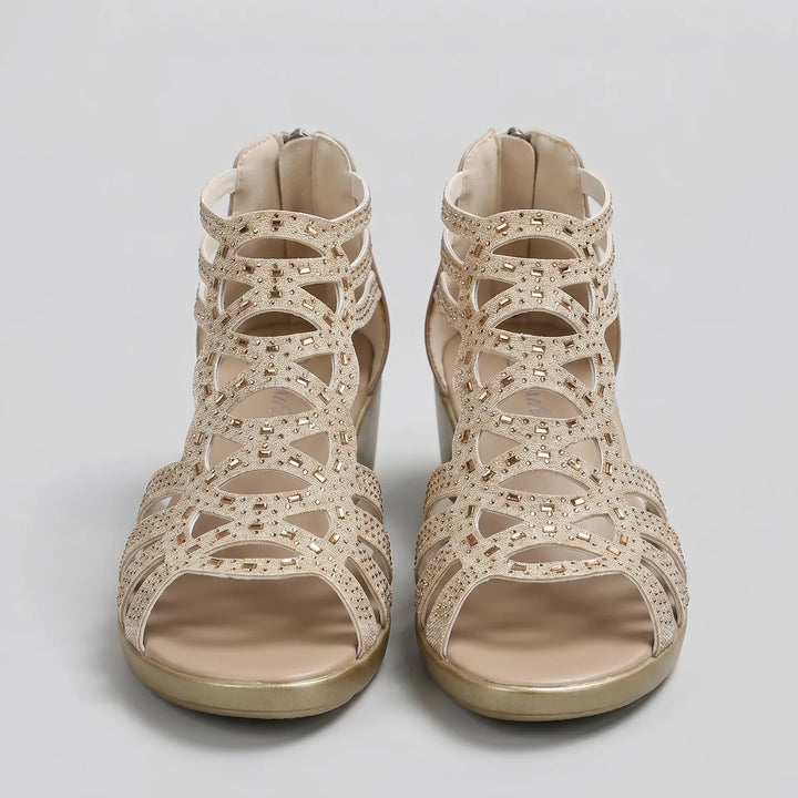 Beige open-toe sandals with cut-out design on a light gray background