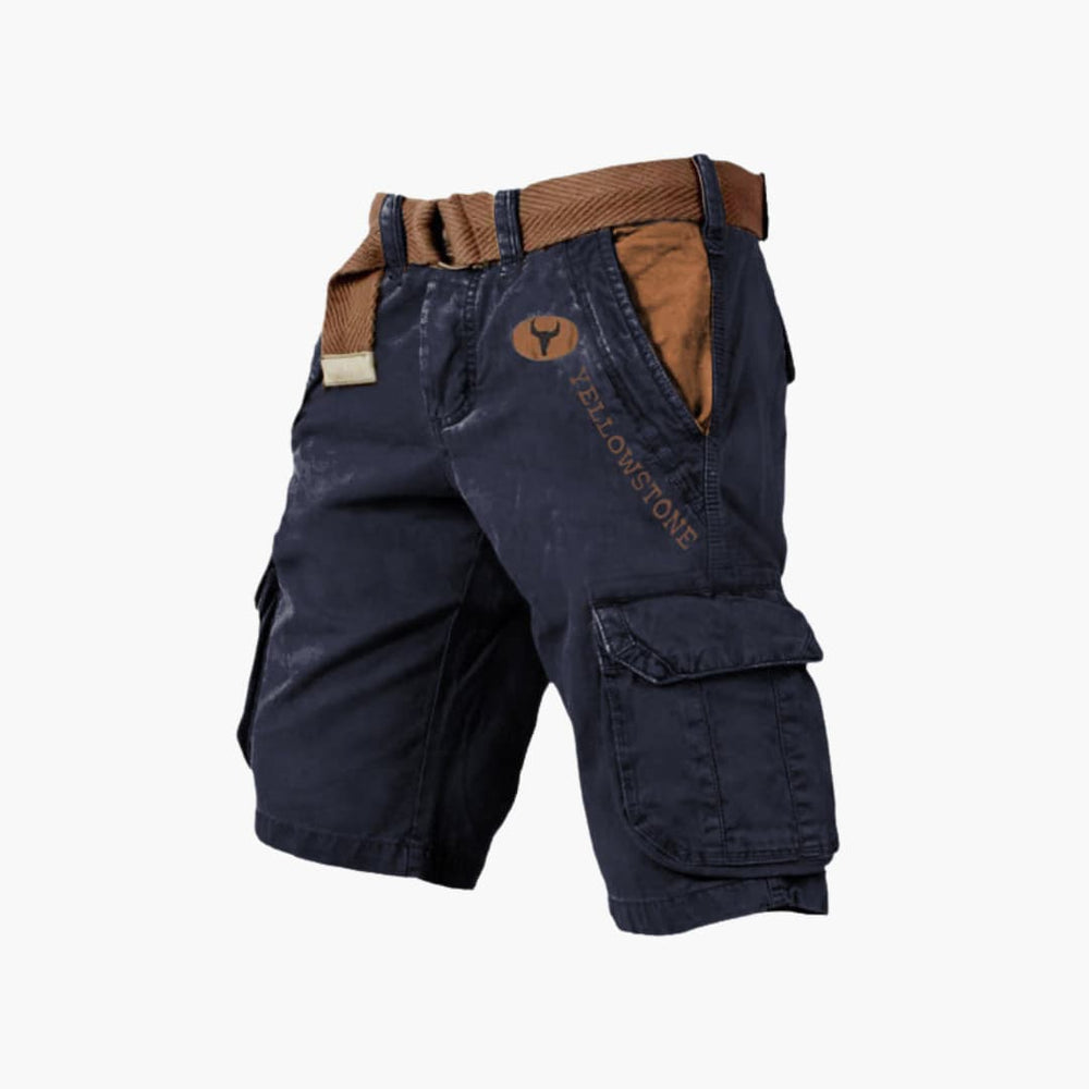 Navy blue knee-length cargo shorts with brown contrast pockets, Yellowstone branding, and a matching woven belt.