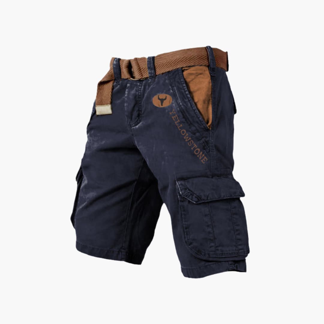 Navy blue knee-length cargo shorts with brown contrast pockets, Yellowstone branding, and a matching woven belt.