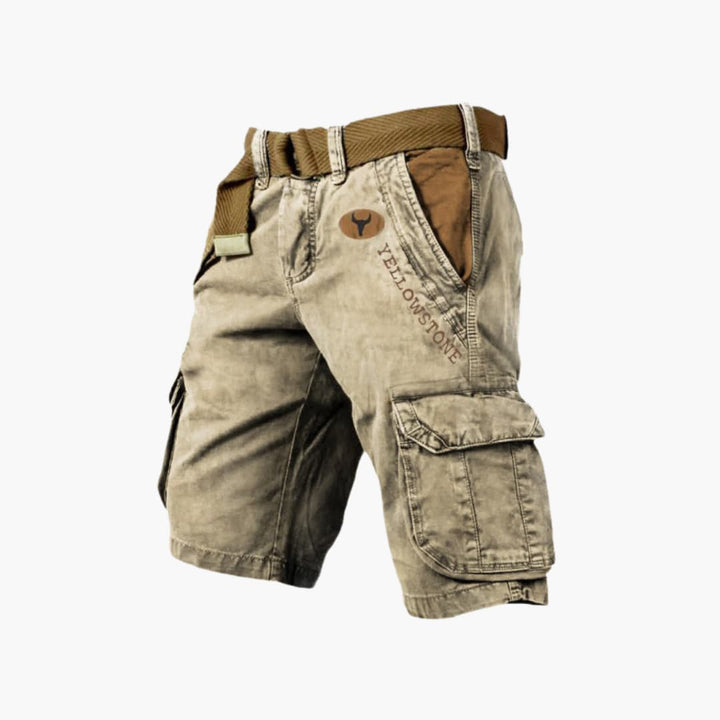 Tan knee-length cargo shorts with side flap pockets, Yellowstone branding, and a brown canvas belt.
