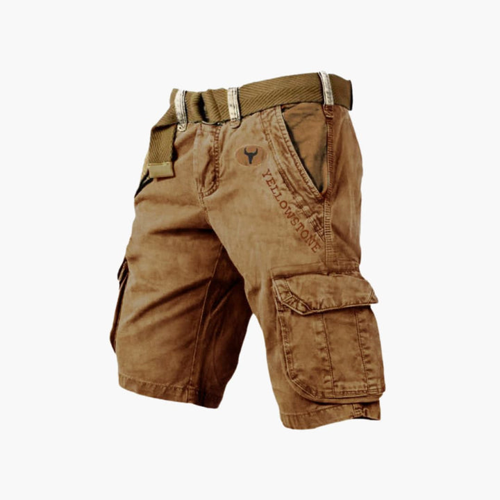 Brown knee-length cargo shorts with side flap pockets, a webbed belt, and Yellowstone branding on the front.