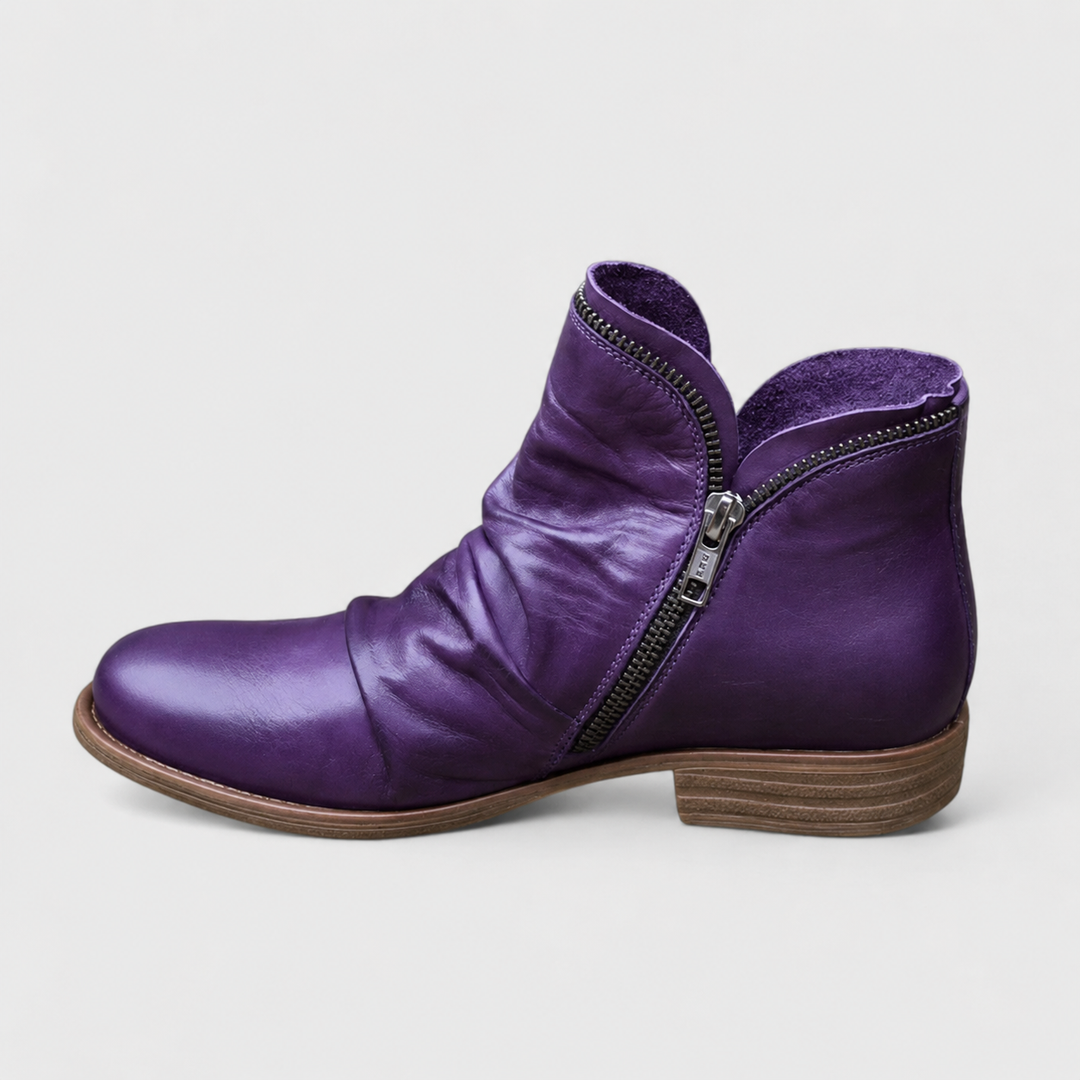 Purple Tilly ankle boots featuring a soft ruched leather upper, side zip closure, and a comfortable low block heel.