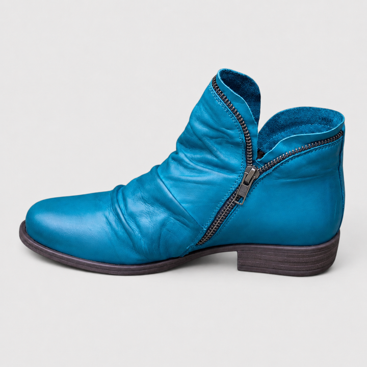 Bright blue Tilly ankle boots featuring a soft ruched upper, side zip closure, and a comfortable low block heel.