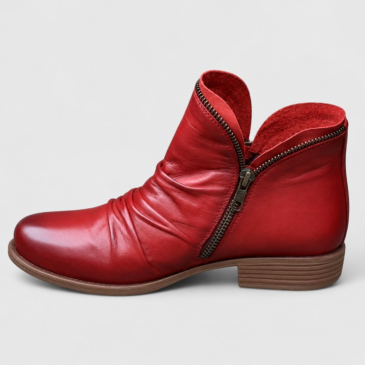 Red Tilly ankle boots featuring a soft ruched upper, side zip closure, and a comfortable low block heel.