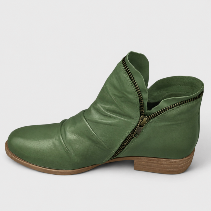 Sage green Tilly ankle boots featuring a soft ruched finish, side zip closure, and a comfortable low block heel.