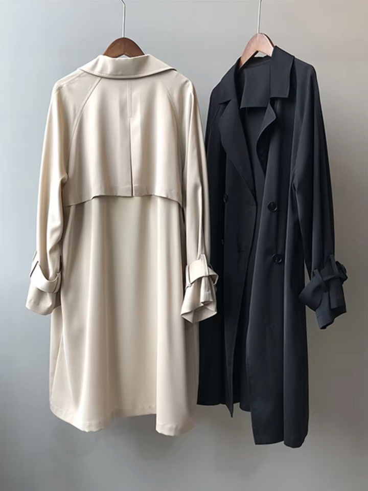 Beige and black Vivienne waterproof double-breasted trench coats with notch lapels and buttoned sleeve tabs.