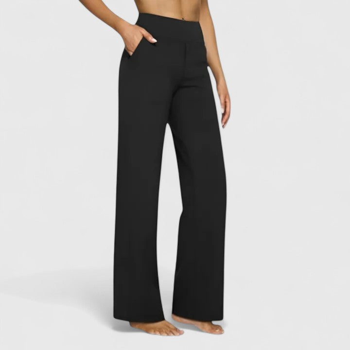 Vivienne black pull-on trousers with a wide waistband, deep side pockets, and a relaxed wide-leg fit.