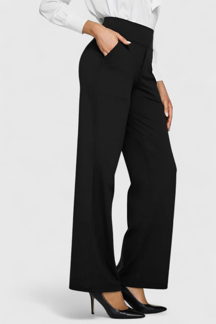 Vivienne black pull-on wide waistband trousers with deep side pockets, styled with a white blouse and heels.