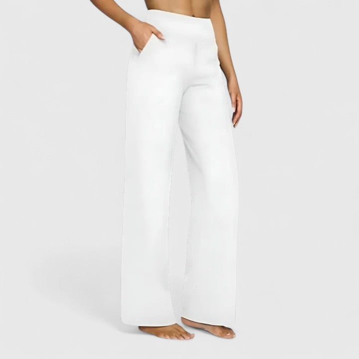 Vivienne women's white pull-on wide waistband trousers with deep side pockets, offering relaxed comfort and a refined finish.
