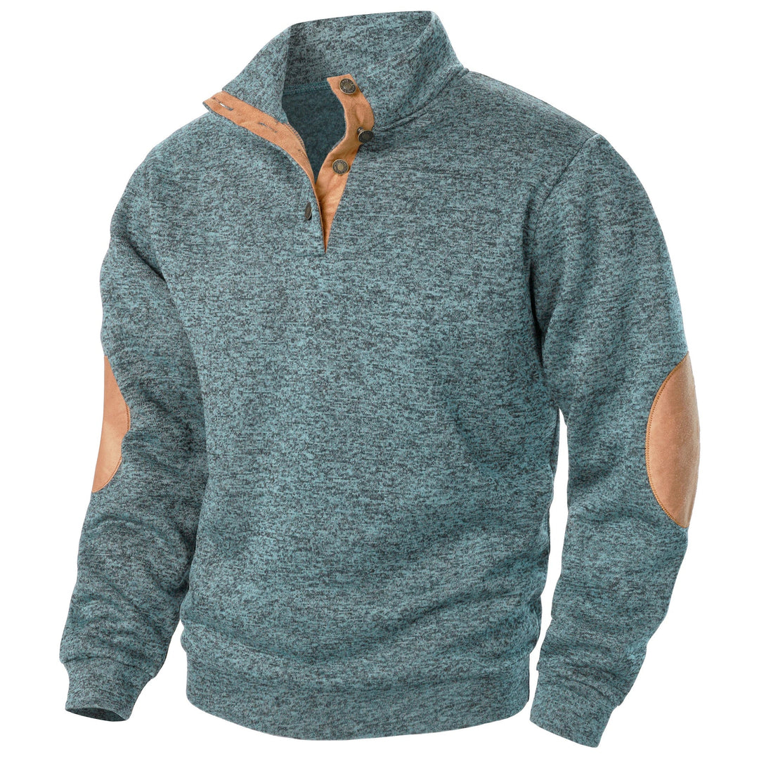 Blue marled knit quarter-button sweater with tan suede-style collar trim and elbow patches.