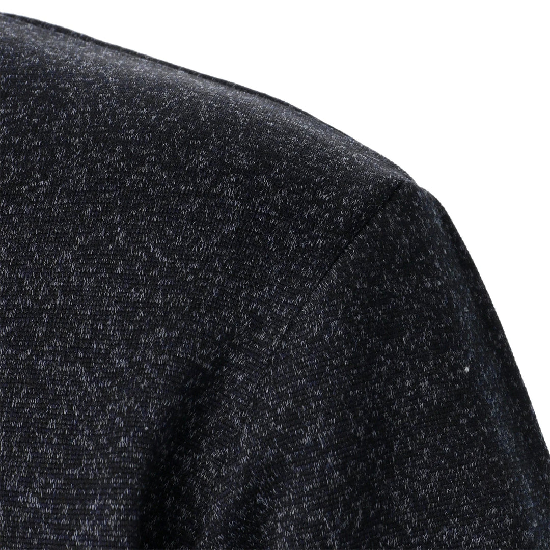 Close-up of a charcoal marled knit fabric on the shoulder of a men's Wesley quarter-button sweater.