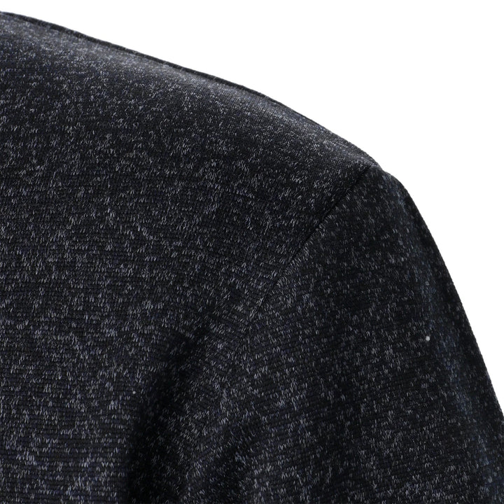 Close-up of a charcoal marled knit fabric on the shoulder of a men's Wesley quarter-button sweater.