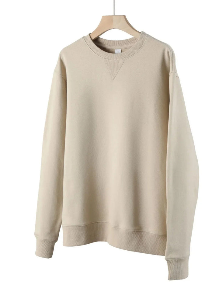 Beige men's crew neck cotton sweatshirt with ribbed trim and signature V-stitch detail, hanging on a wooden hanger.