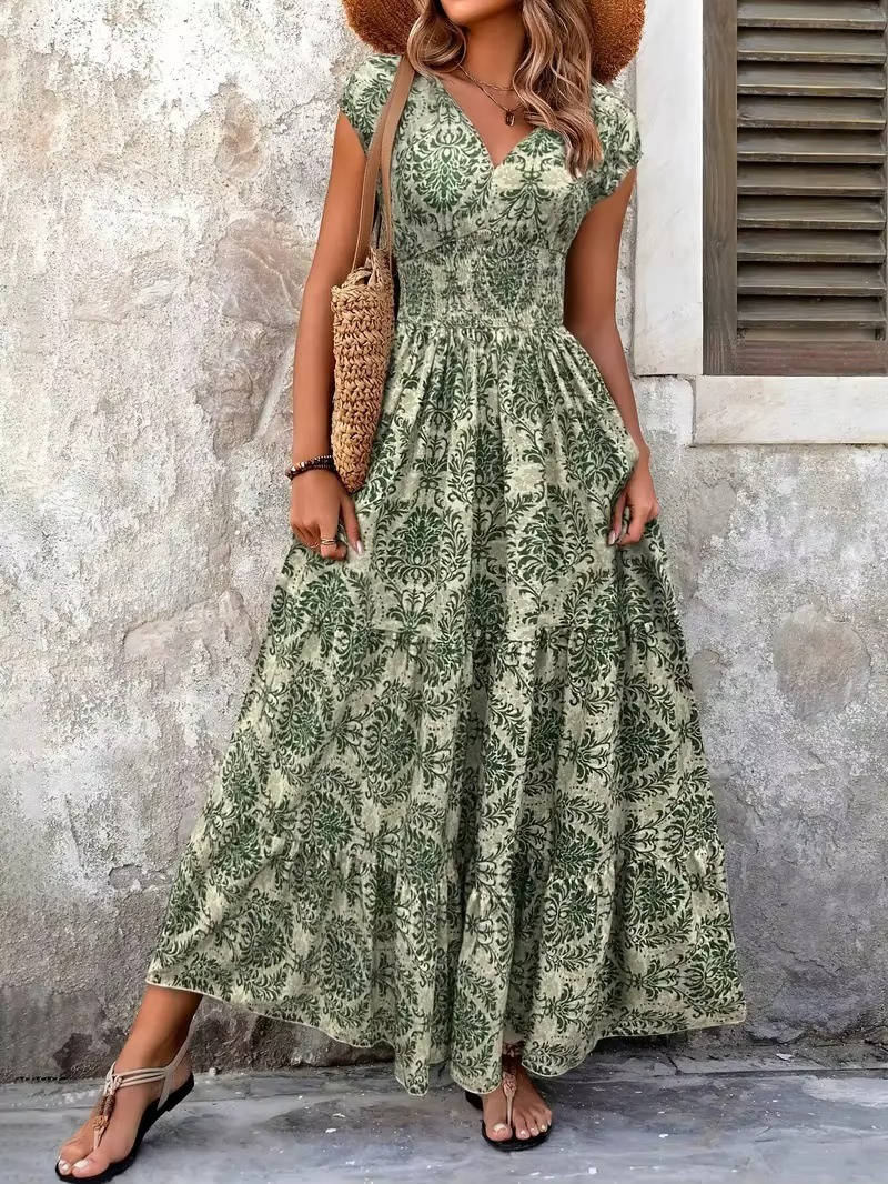 Green floral boho maxi dress with a smocked bodice, V-neckline, cap sleeves, and a tiered skirt.