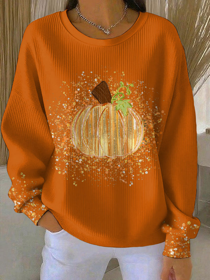 Orange ribbed crew neck sweatshirt featuring a glittery pumpkin graphic on the front and scattered sparkles on the sleeves.